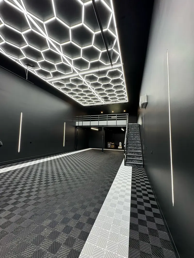 Modern commercial space with custom hexagon LED ceiling lighting installed by a professional electrician, showcasing quality workmanship and advanced electrical design for a high-end interior build.